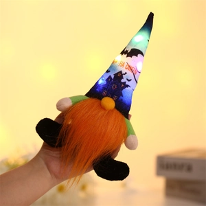 Detail of hand-held glowing Halloween gnome with orange beard and LED lights on its hat