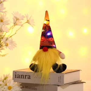 Close-up of Halloween glowing gnome with LED lights and festive patterns on the pointed hat