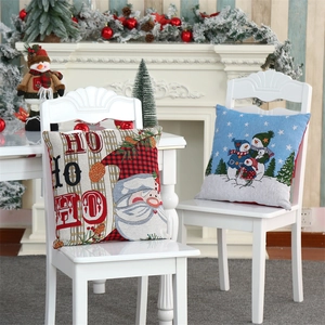 Detailed texture of Christmas pillow covers featuring Santa and snowmen on a chair