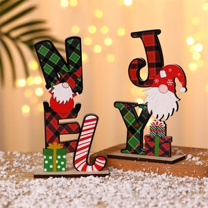 Wooden Christmas gnome letter ornaments with red green plaid pattern on a snowy base