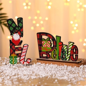 Detailed macro view of festive wooden NOEL and Believe ornaments on a snowy table