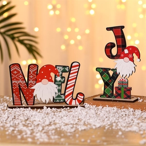 Detail of wooden Noel and Joy Christmas gnome signs with red and green festive decor