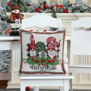 Detailed Christmas gnome pillow cover with Merry Everything text on a white chair