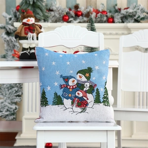 Christmas snowman family jacquard cushion cover displayed on a white wooden chair