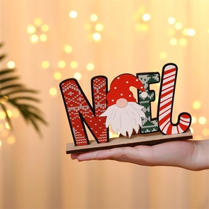 Detailed view of hand-held wooden NOEL sign with gnome character and festive knit texture