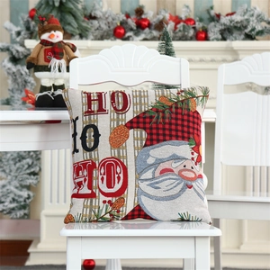 Close-up of Christmas gnome pillowcase with red plaid patterns on a cozy white chair