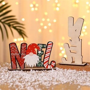 Close-up of wooden NOEL Christmas desktop ornament with gnome design and snowy background