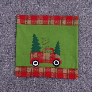 Close-up of Christmas velvet pillowcase with red truck embroidery and plaid trim