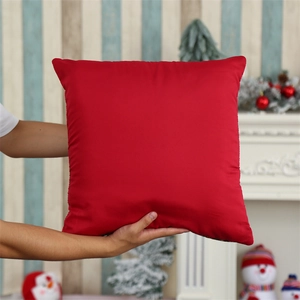 Detailed view of red Christmas gnome pillow cover on soft textured fabric material