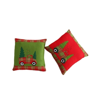 Christmas throw pillows with embroidered truck and tree on red and green velvet fabric