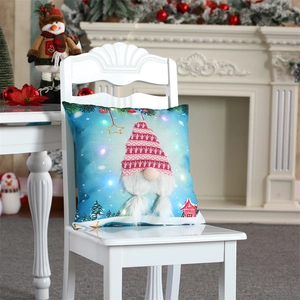 Detail of LED Christmas gnome pillow with plush 3D ornaments on a blue starry background