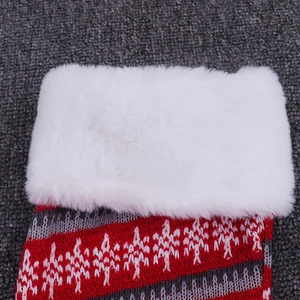 Close-up of knit Christmas stocking with festive red pattern and soft faux fur cuff