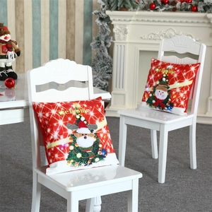 Detail of LED Christmas pillow cases featuring reindeer and snowman on a chair