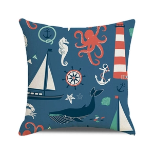 Close-up of nautical patterns with whales and anchors on a square blue sofa cushion cover