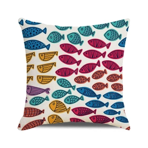 Close-up of textured linen fabric and colorful watercolor fish pattern on cushion cover