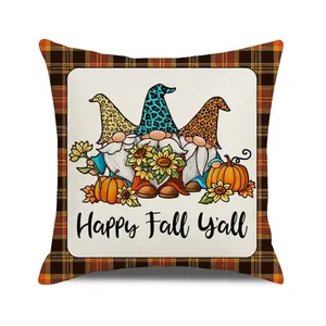 Detail of fall gnome pillow cover with sunflowers, pumpkins and black orange checkered border