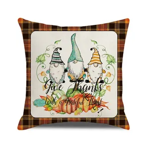 Detail of Thanksgiving gnome pillowcase with orange plaid border and autumn pumpkin print
