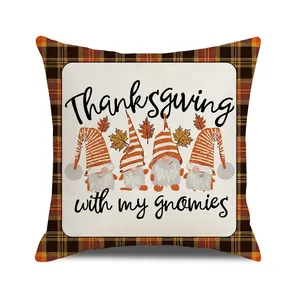 Detail of Thanksgiving pillow case with gnomes and maple leaf on linen texture