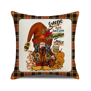 Close-up of autumn gnome pillow cover featuring orange plaid edges and pumpkin spice text