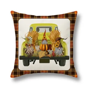 Detail of harvest gnome truck design on faux linen pillow cover with plaid borders