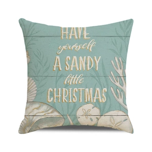 Detail of square seaside Christmas pillow cover with sandy texture and seashell patterns