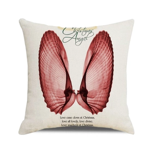 Close-up of square linen pillow cover featuring red wings and Christmas Angel text