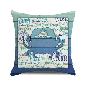 Detail of square cushion cover with blue crab silhouette on teal wood grain background
