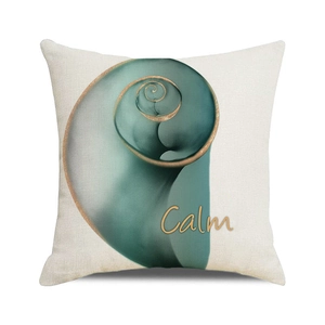 Detailed close-up of a linen pillow cover featuring a teal conch design and Calm text