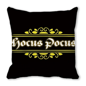 Close-up of black Halloween pillowcase with white Hocus Pocus text and yellow scrolls