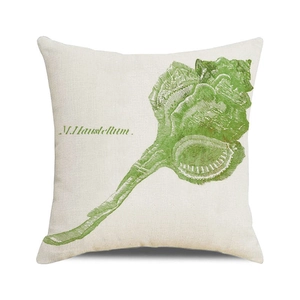 Close-up of beige linen pillow cover with a green murex seashell watercolor print