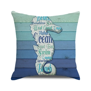 Detail of square pillowcase with seahorse silhouette and coastal typography on wood print