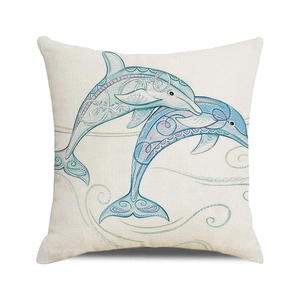 Close-up of linen pillowcase with teal dolphin mandala patterns on cream fabric