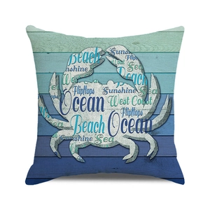 Nautical crab pillow cover with beach words typography on a coastal wood grain background