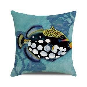 Close-up of clown triggerfish and blue coral print on square cotton linen pillow cover