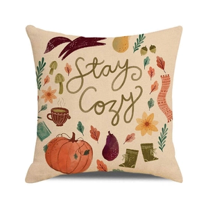 Close-up of linen pillowcase with Stay Cozy text, fox and autumn harvest illustration