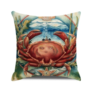 Detail of watercolor crab print on linen cushion cover with starfish and shells