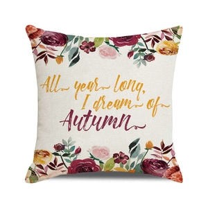 Detailed texture of linen cushion cover with Autumn floral print and typography
