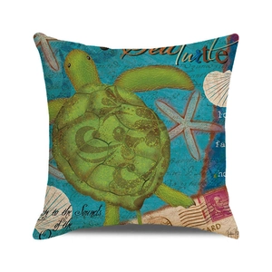 Detail of square cushion cover with green sea turtle illustration and vintage nautical print