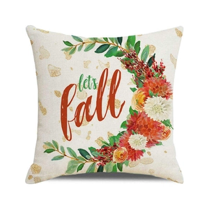 Detailed texture of linen cushion cover featuring autumn flowers and let's fall script