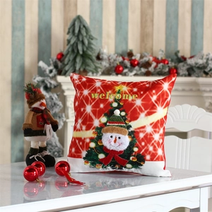 Close-up of a festive red Christmas pillowcase with snowman pattern in a warm holiday setting