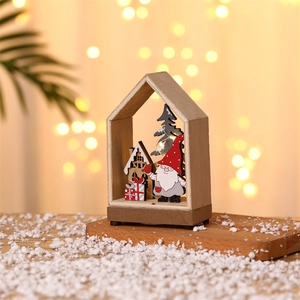 Lighted wooden Christmas cabin scene with gnome, snowy tree and festive gift box