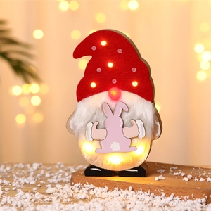 Detail of light-up Easter gnome decor with LED glowing hat and warm wooden base