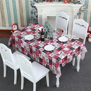 Close-up of Christmas tablecloth with gnome print and festive checkered holiday pattern