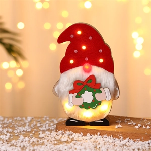 Christmas Gnome LED wooden decor with red felt hat and warm glowing lights on a snowy base