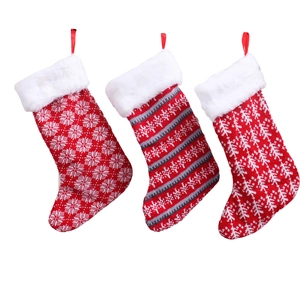 Three red knitted Christmas stockings with snowflake patterns and white faux fur cuffs