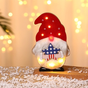 Close-up of lighted wooden Christmas gnome with American flag star and warm LED glow