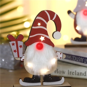 Glow wood Christmas gnome ornament with red striped hat and warm LED lights