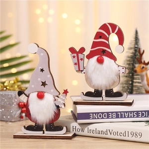 Lighted wooden Christmas gnome ornaments with plush beards and skates on a festive table