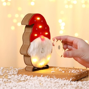 Close-up of LED glowing Christmas gnome with magnetic wooden parts on snow