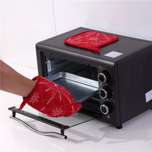 Red quilted Christmas oven mitt and pot holder set used for hot trays in the kitchen